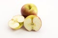 Two half apples and whole apple sliced Ã¢â¬â¹Ã¢â¬â¹on a white background